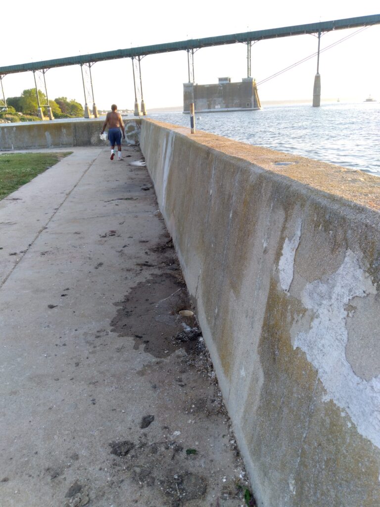 a person walking on a path by a body of water (MyCoast AI)