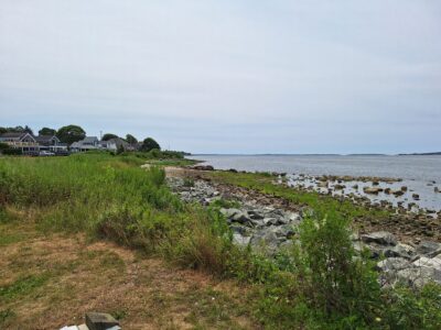 a rocky beach with houses and trees (MyCoast AI)