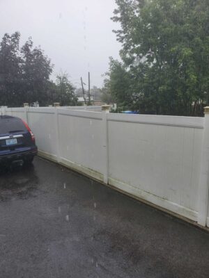 a white wall with a car parked in front of it (MyCoast AI)