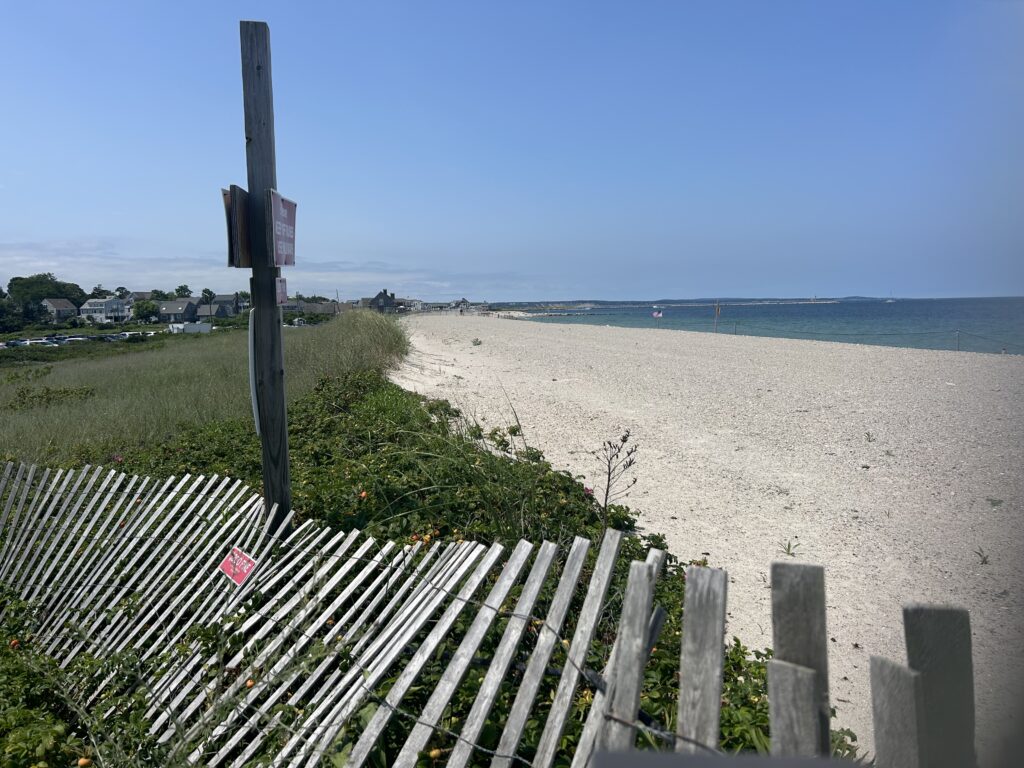 a white fence on a beach (MyCoast AI)