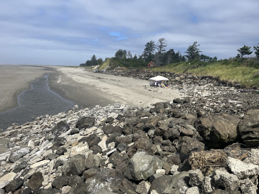 a rocky beach with a white tent (MyCoast AI)