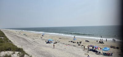 a beach with people and umbrellas (MyCoast AI)