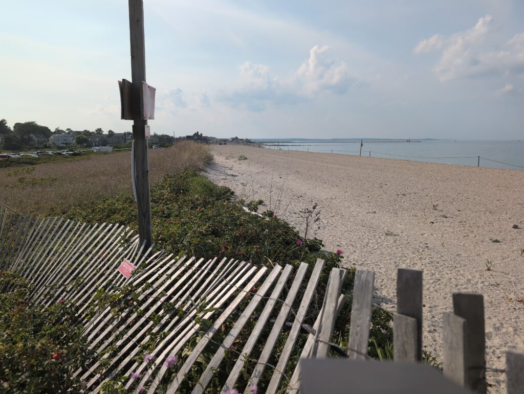 a beach with a fence and a sign (MyCoast AI)