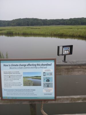 a sign on a wooden dock (MyCoast AI)