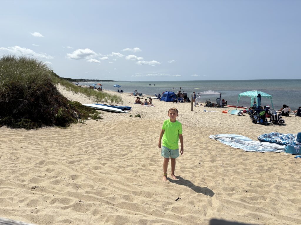 a boy standing on a beach (MyCoast AI)