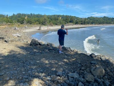 a man standing on a rocky beach (MyCoast AI)