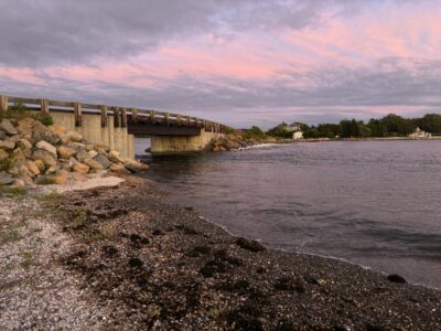 a rocky beach with a bridge (MyCoast AI)
