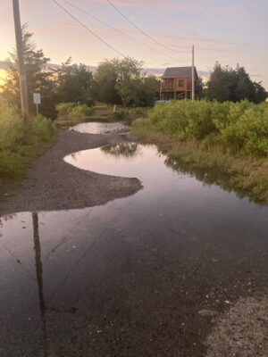 a flooded road with a house in the background (MyCoast AI)