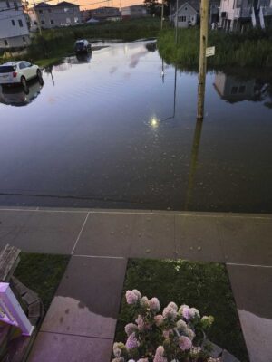 a flooded street with a car parked on the side (MyCoast AI)