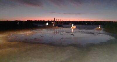 a body of water with a boat in it and a city in the background (MyCoast AI)