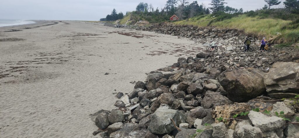 a rocky beach with people riding bikes (MyCoast AI)