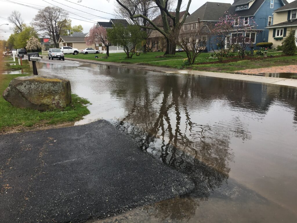 a flooded street with houses and trees (MyCoast AI)