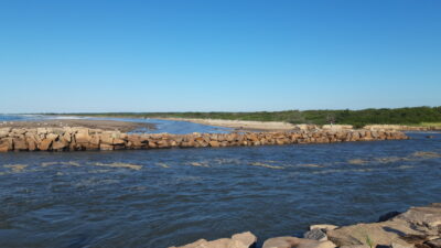 a body of water with rocks and land in the background (MyCoast AI)