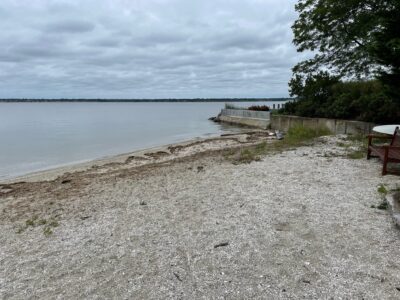 a beach with a bench and a body of water (MyCoast AI)