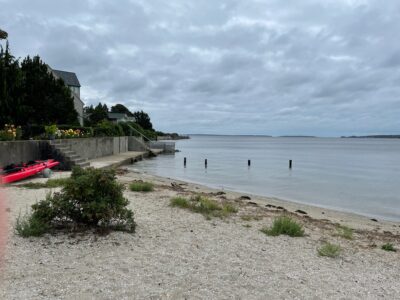 a beach with a body of water and a boat (MyCoast AI)