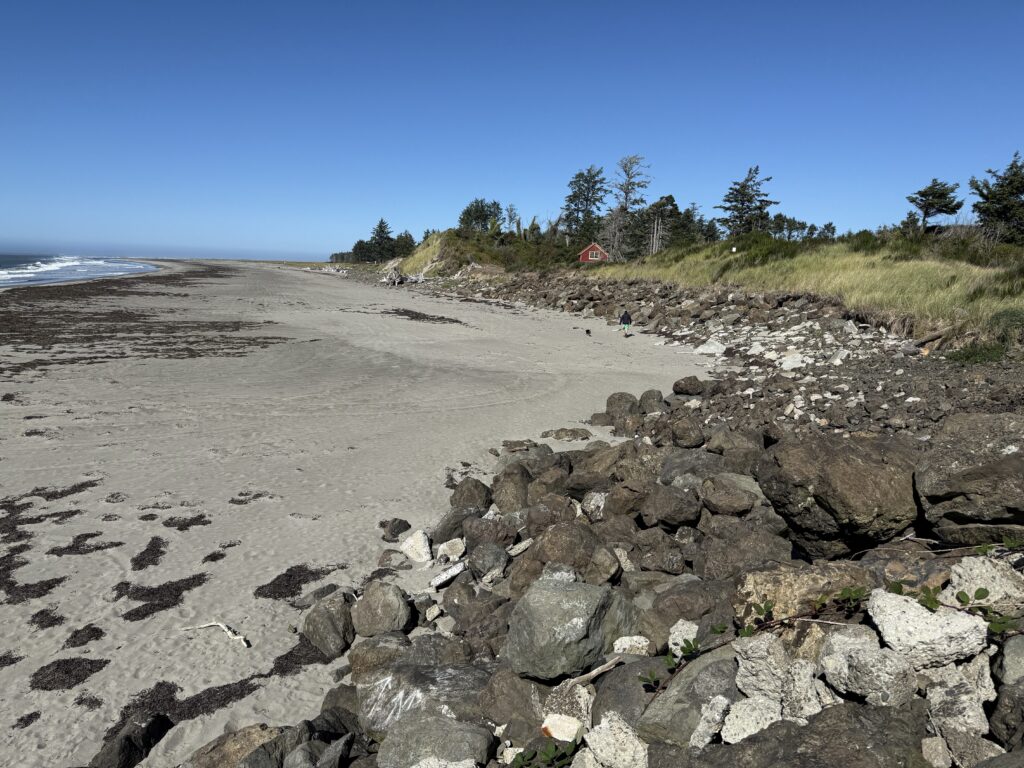 a rocky beach with a red house (MyCoast AI)