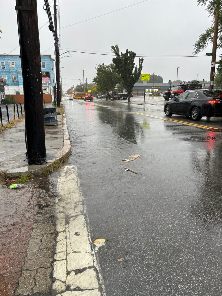 a street with cars and a street with trash on the ground (MyCoast AI)