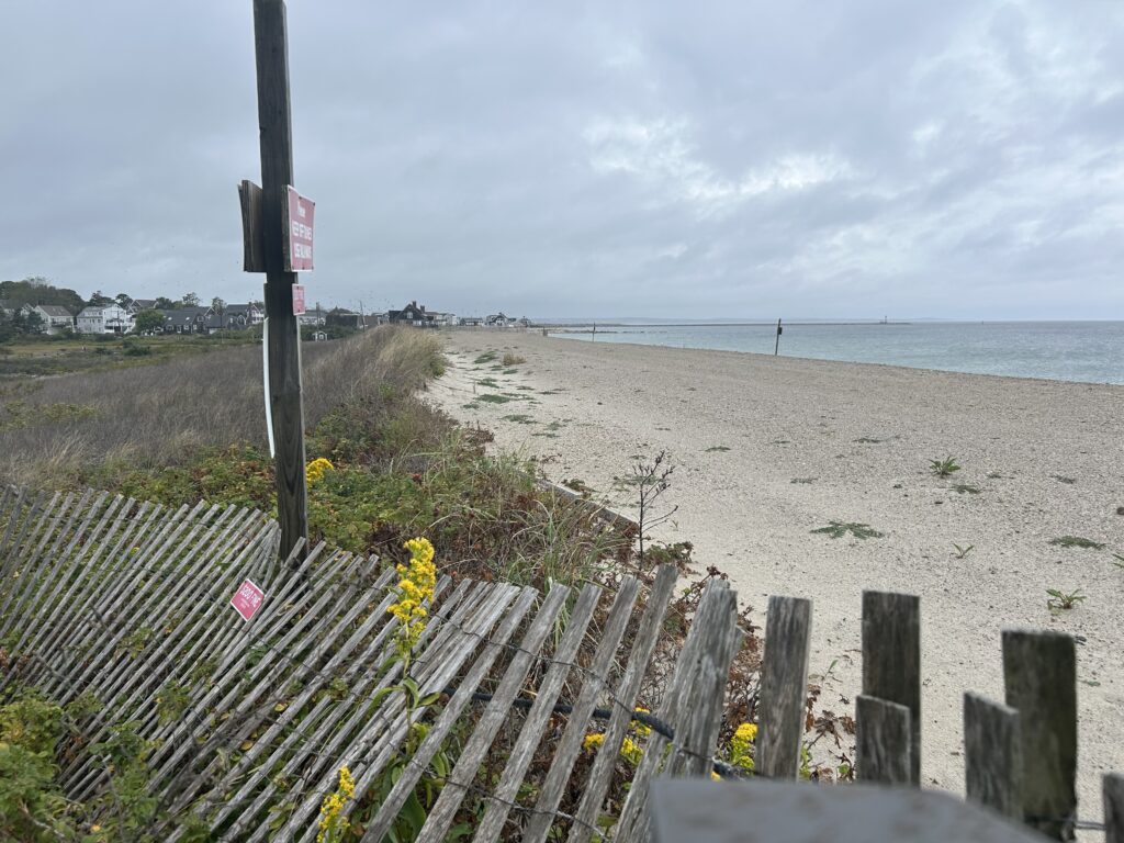 a beach with a fence and a sign (MyCoast AI)