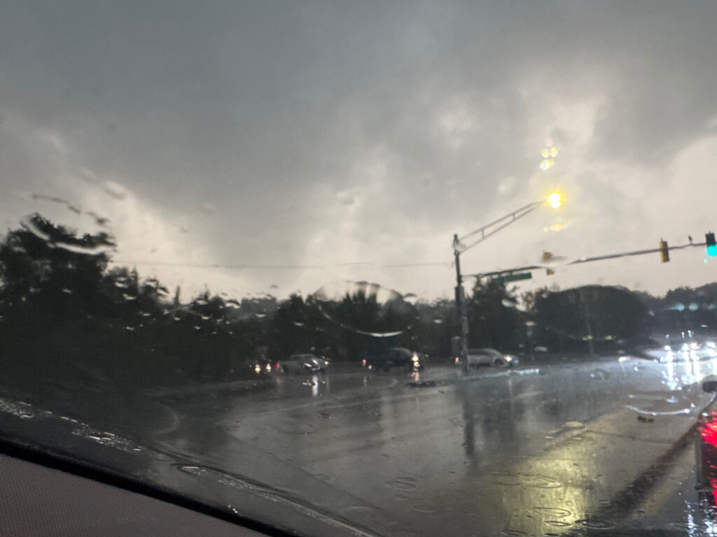 a rainy street with cars and a street light (MyCoast AI)