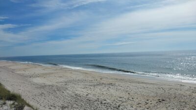 a sandy beach with waves crashing on it (MyCoast AI)