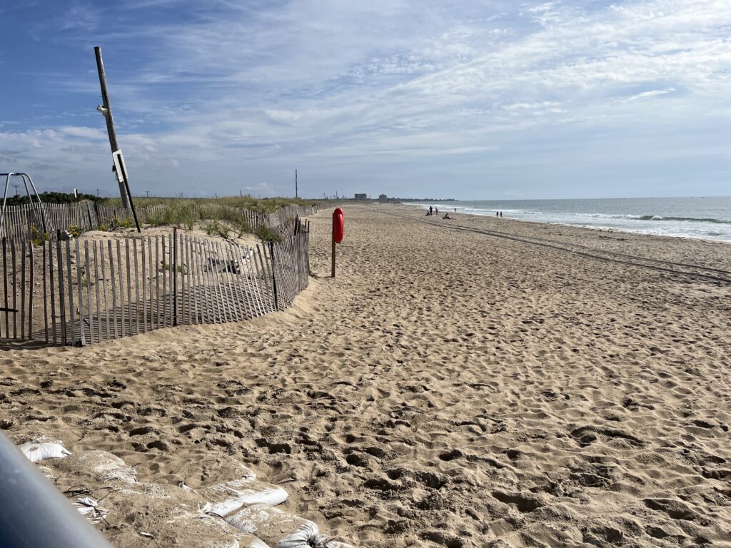 a sandy beach with a fence (MyCoast AI)
