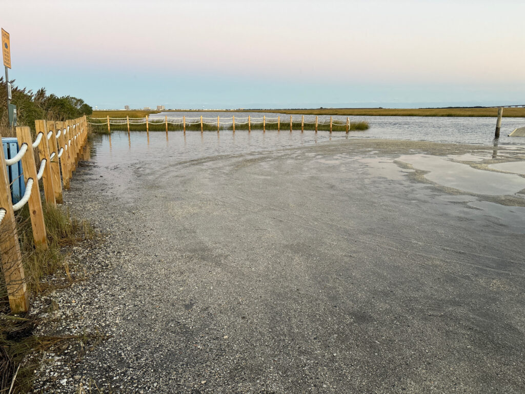 a road with a fence and water on the side (MyCoast AI)