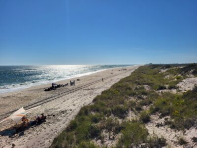 a beach with people and tents (MyCoast AI)