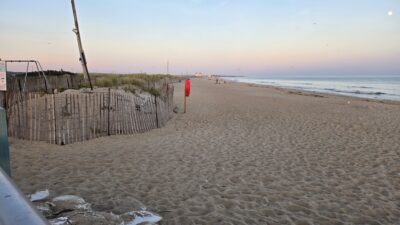 a sandy beach with a fence (MyCoast AI)