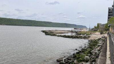 a body of water with rocks and a fence around it (MyCoast AI)