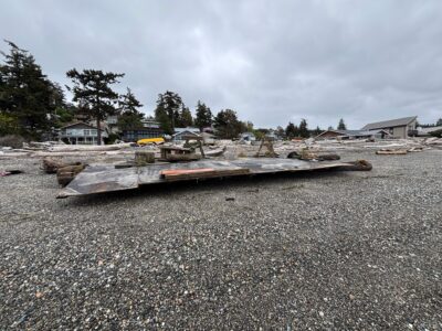 a pile of wood on a gravel road (MyCoast AI)